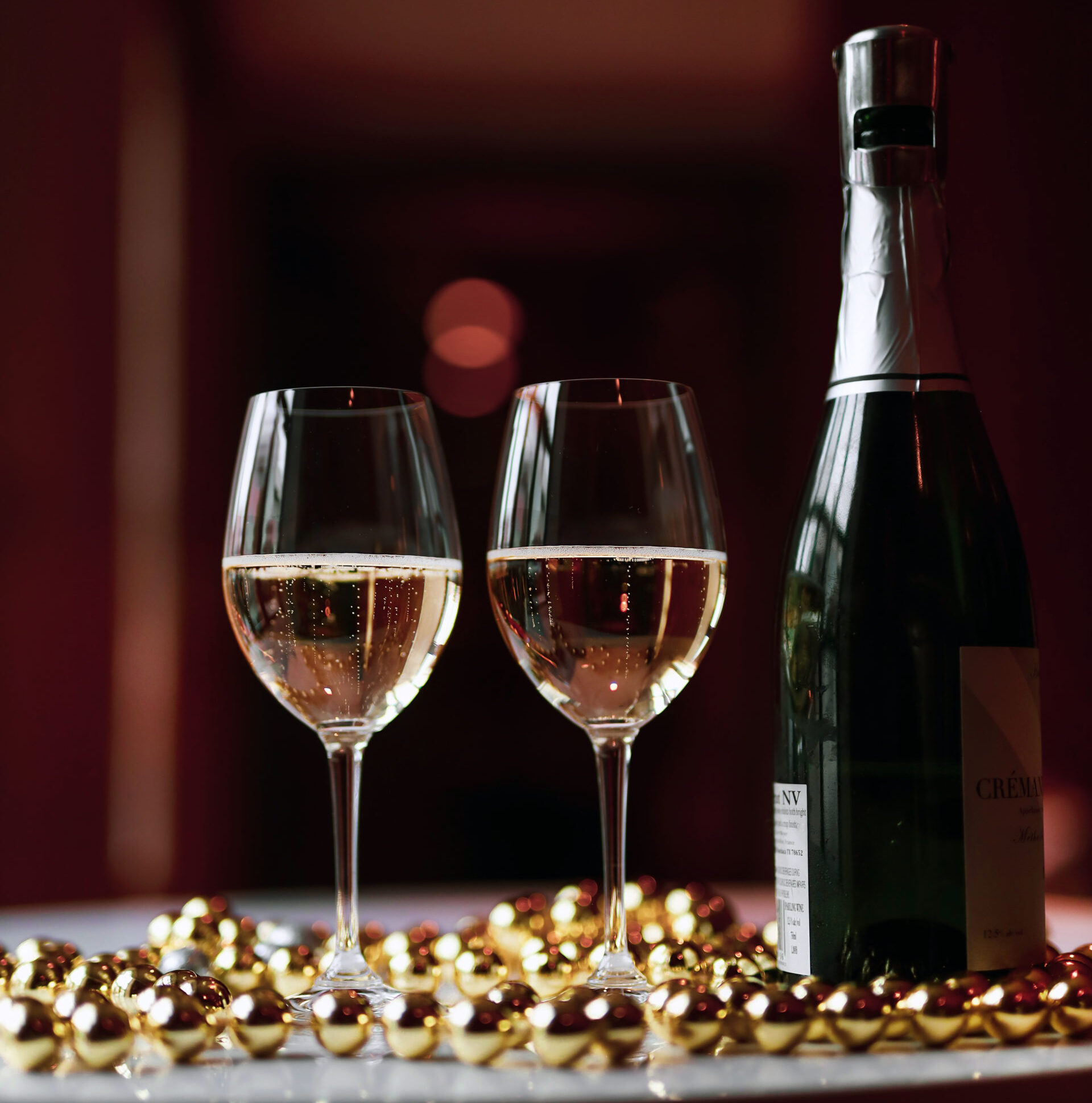 Two glasses of champagne on a table.